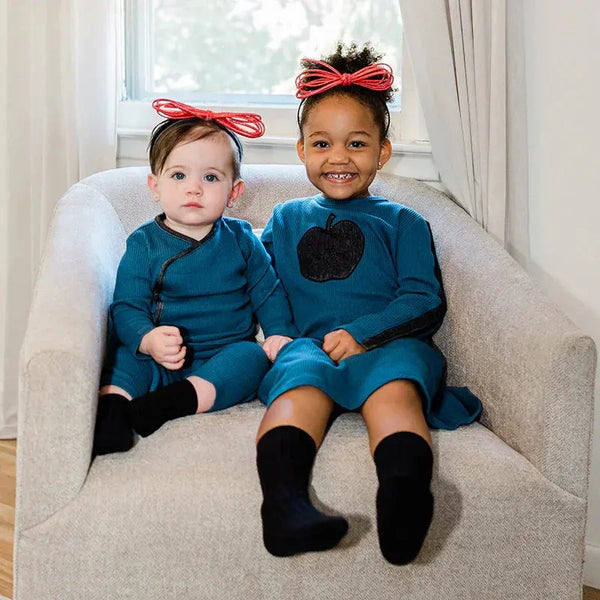 Toddler wearing a denim and ribbed wrap coordinated set, cozy matching sibling style for casual family outings.