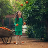 Young girl wearing a green orange vibrant set, bold matching sister style for energetic family fun.