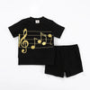 Little gentleman in a black musical jersey set, coordinated brother outfit for harmonious family celebrations.