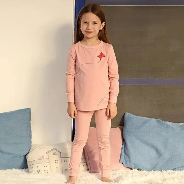 Little lady wearing a kite embroidery detailed set, whimsical matching sister outfit for joyful family moments.