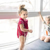 Toddler in a boat print and red denim coordinated set, cute matching sibling outfit for nautical family adventures.