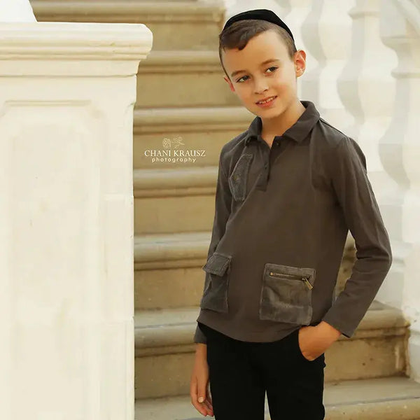 Young boy in an irregular pocket unique set, modern matching brother style for contemporary family looks.