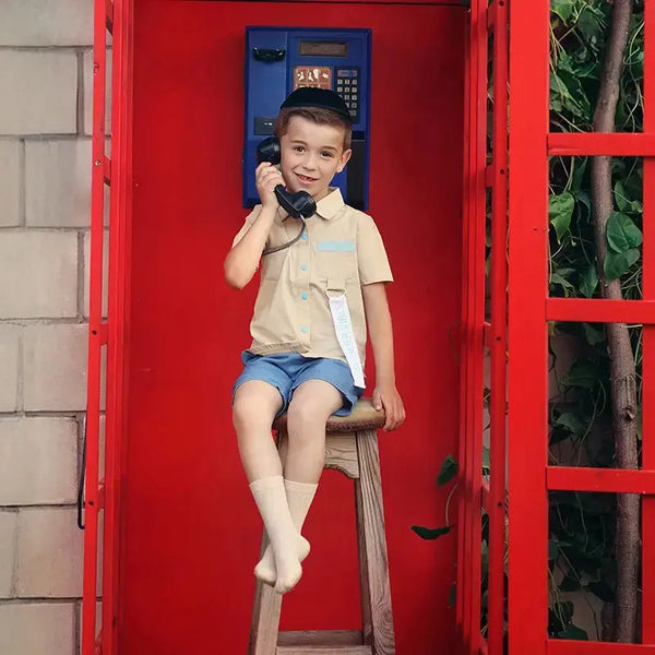 Little gentleman in a summer vibes print set, breezy matching brother outfit for relaxed family gatherings.