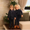 Adorable baby in a navy floral collar Shabbos set, elegant matching sibling outfit for traditional Shabbat dinners.