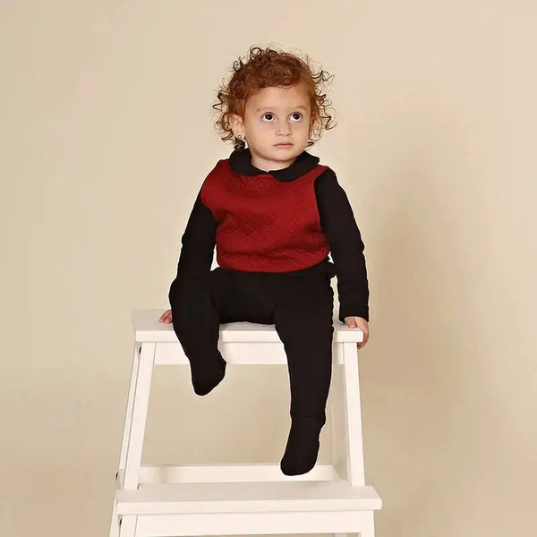 Adorable baby wearing a quilted Shabbos lounge set, cozy matching sibling outfit for relaxed Shabbat at home.