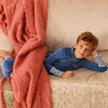 Young boy in a mail logo blue pink velvet set, colorful matching brother style for fun family gatherings.