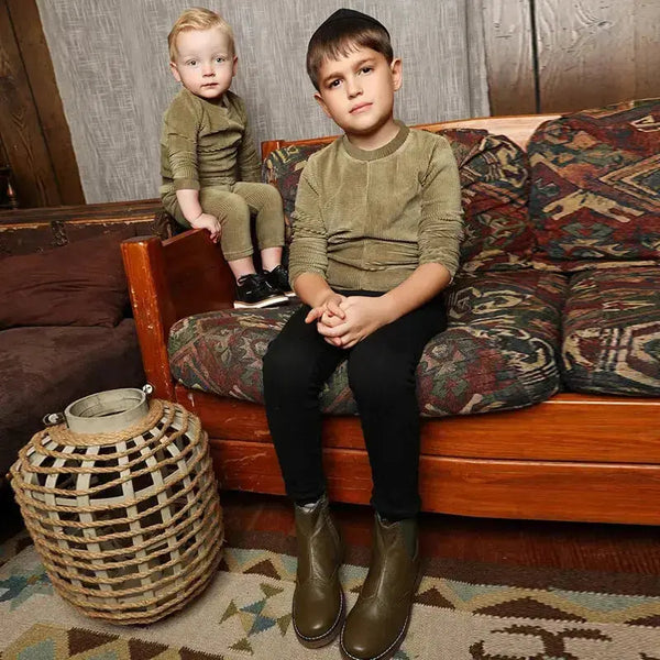 Young boy dressed in an olive corduroy textured set, earthy matching brother style for cozy family moments.