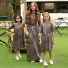 Young girl wearing a ribbed grey melange soft set, neutral matching sister style for versatile family wear.