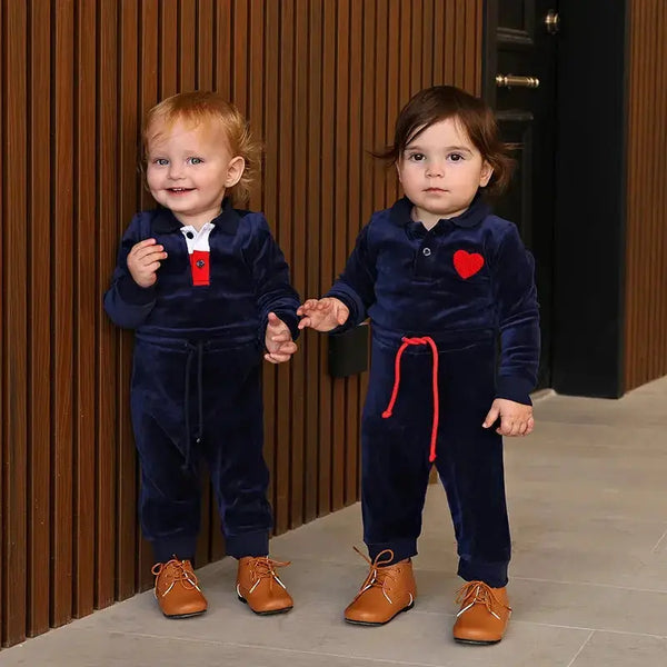 Toddler wearing a luxury navy velour soft set, plush matching sibling outfit for elegant family occasions.