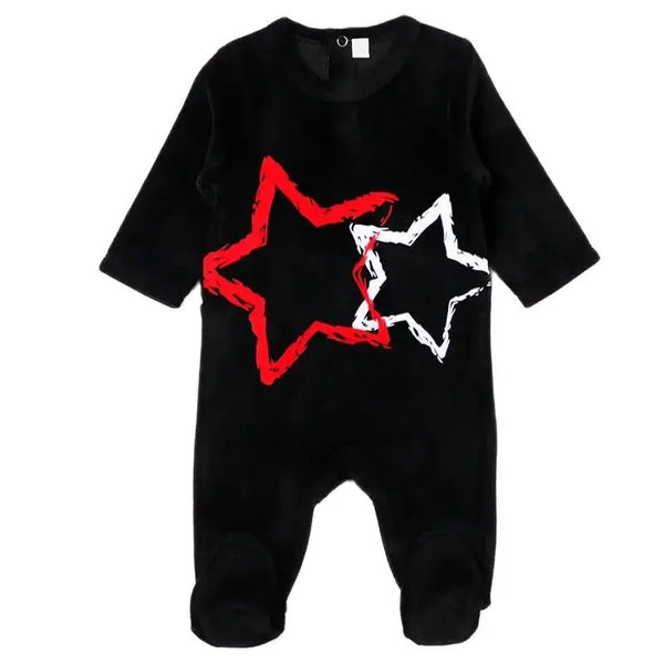 Baby in a velour star footie romper, soft matching sibling outfit for peaceful family nights.
