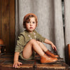 Baby in an olive corduroy coordinated set, earthy matching sibling outfit for cozy family moments.