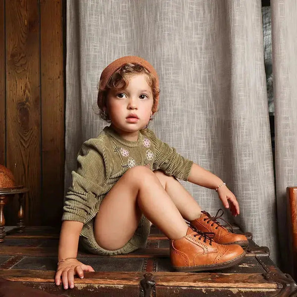 Baby in an olive corduroy coordinated set, earthy matching sibling outfit for cozy family moments.
