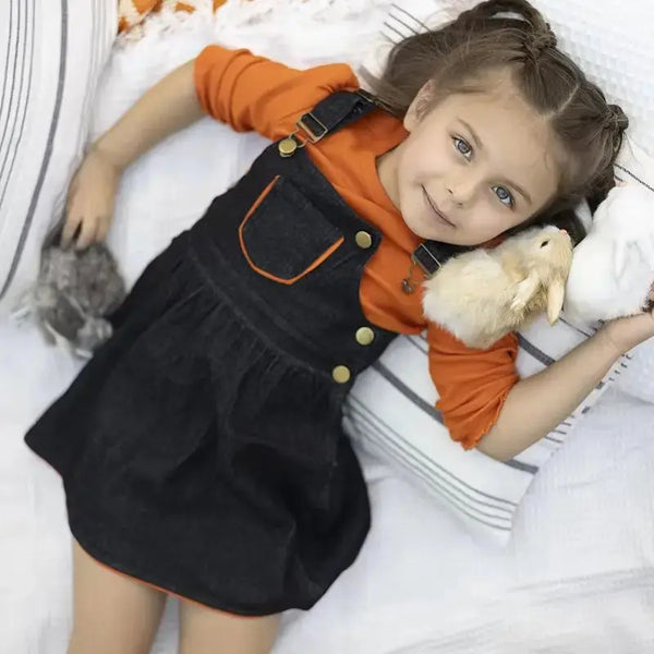 Young girl wearing a black denim classic set, stylish matching sister outfit for casual family outings.