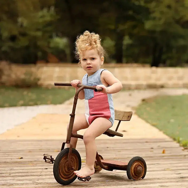 Little one in a pink and white contrast denim set, sweet matching sibling outfit for lovely family photos.