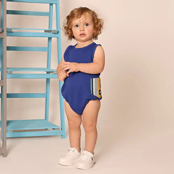 Baby in a striped pocket detailed set, nautical matching sibling outfit for seaside family adventures.