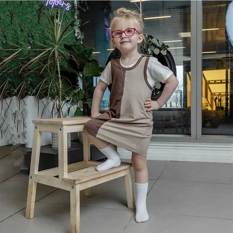 Young girl in a khaki earthy colorblocked set, natural matching sister style for outdoor family adventures.