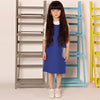 Young girl dressed in a striped pocket nautical set, classic matching sister outfit for seaside adventures.