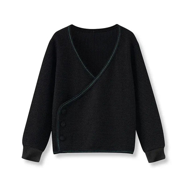 Little gentleman dressed in a black waffle cardigan, refined matching brother outfit for smart family occasions.