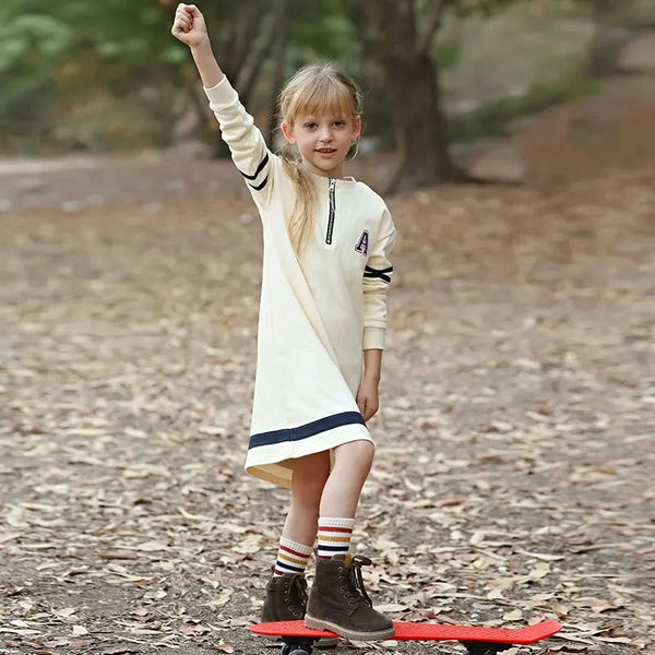 Young girl in a letter A navy stripes set, coordinated matching sister outfit for family celebrations.