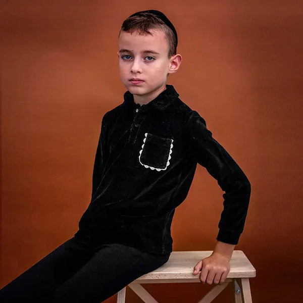 Little gentleman wearing a black brim Shabbos set, coordinated brother outfit for elegant Shabbat gatherings.