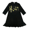 Little lady dressed in a black musical jersey set, harmonious matching sister outfit for celebratory occasions.