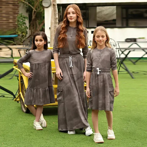 Young girl wearing a ribbed grey melange soft set, neutral matching sister style for versatile family wear.