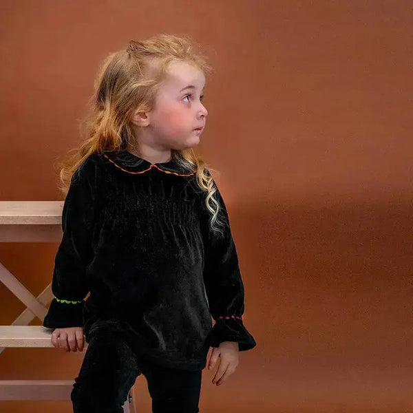 Baby wearing an elegant black brim Shabbos set, coordinated family collection piece for Shabbat dinner.