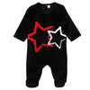 Baby in a velour star footie romper, soft matching sibling outfit for peaceful family nights.