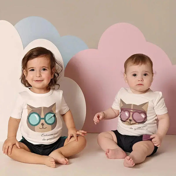 Toddler in a purrfectly chill kitten print set, adorable matching sibling outfit for playful family fun.